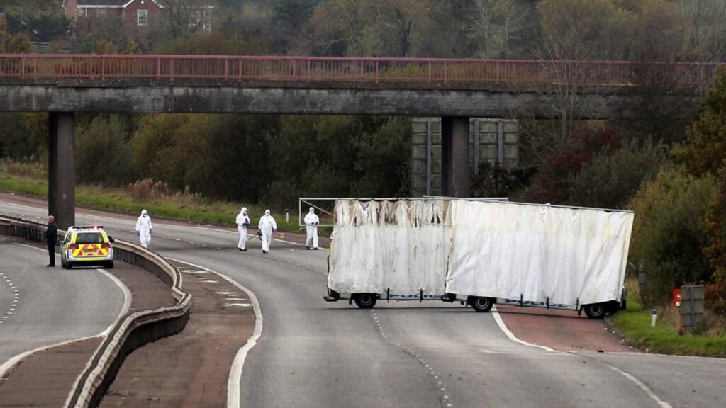 Forensic officers search the scene on the M1 motorway where prison officer David Black was shot as he drove near the town of Lurgan, Northern Ireland on November 1st, 2012. Photograph: Reuters