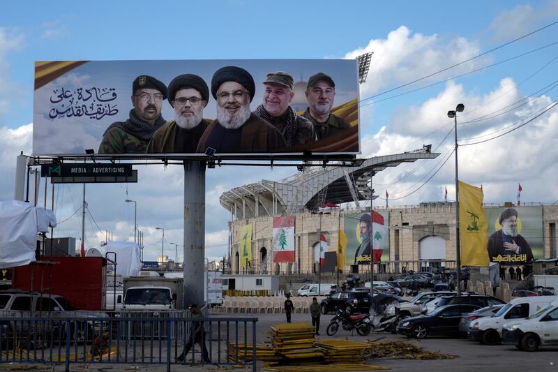 A billboard in Beirut with pictures of prominent figures including late Hizbullah leader Hassan Nasrallah (centre). Photograph: Bilal Hussein/AP