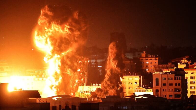 Fire and smoke rise above buildings in Gaza City as Israeli warplanes target the Palestinian enclave on Sunday. Photograph: Anas Baba/AFP/Getty Images