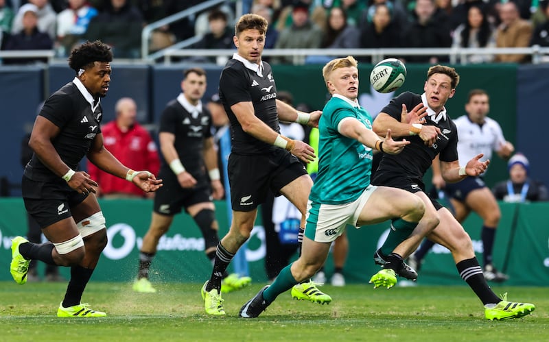 Ireland's Tommy O’Brien under pressure from New Zealand's Cam Roigard. Photograph: Gary Carr/Inpho