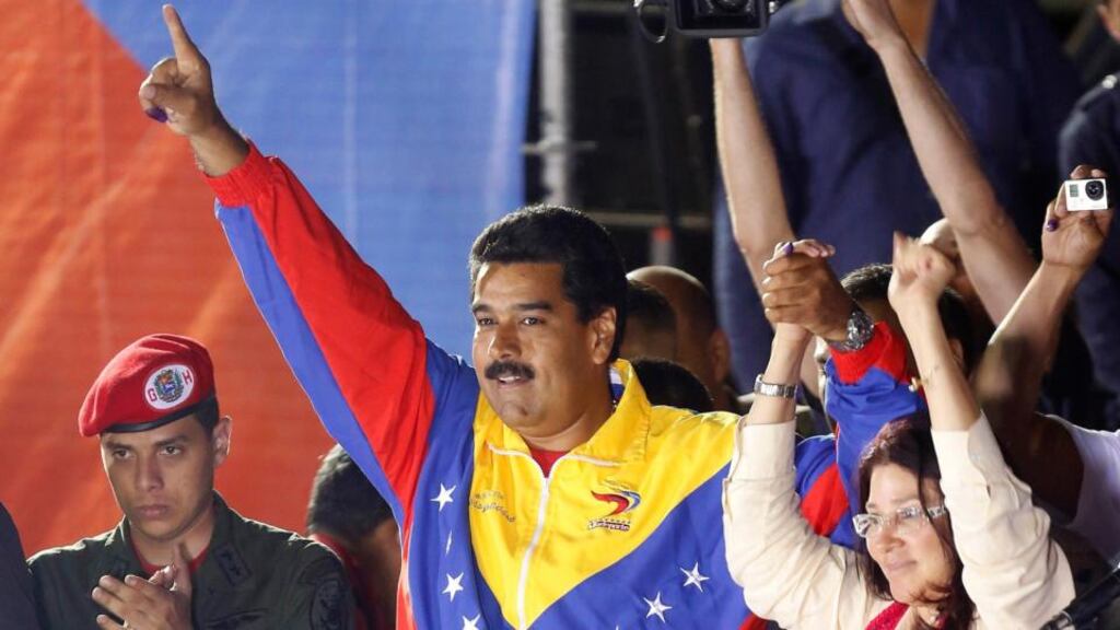 Venezuelan presidential candidate Nicolas Maduro and his wife Cilia Flores celebrate after the official results gave him a victory in the balloting, in Caracas yesterday. Photograph: Reuters