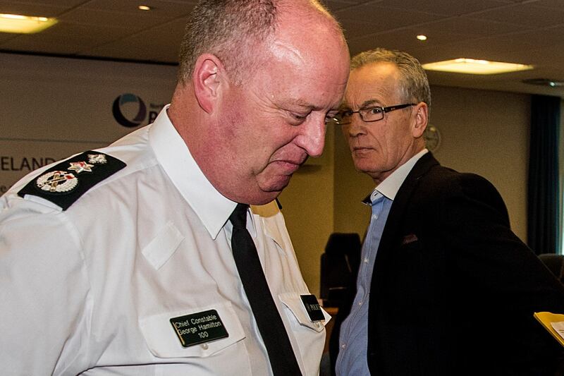 Sinn Féin’s Policing Board member Gerry Kelly (at back) looks on as George Hamilton walks to the speak with media at the Northern Ireland Policing Board Headquarters in Belfast on Tuesday. Photograph: Liam McBurney/PA Wire