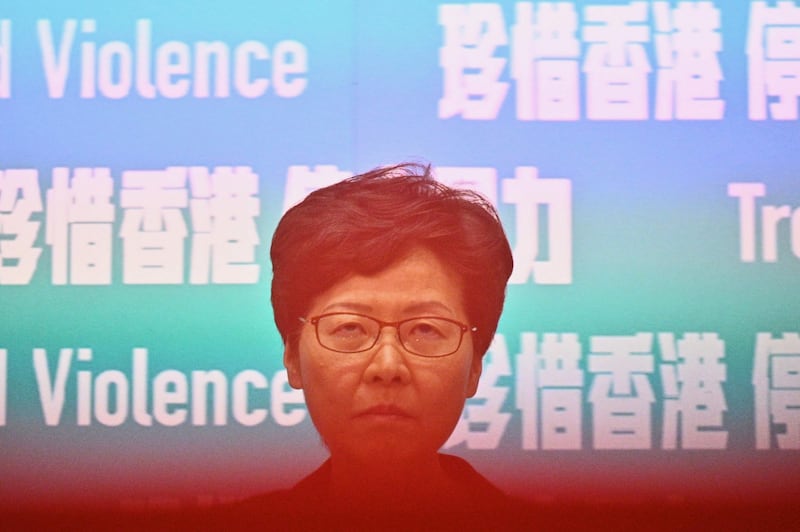 On Friday, Hong Kong’s leader Carrie Lam, partially obscured here by a rope to keep the media at a distance, invoked a rarely used colonial-era emergency law to ban people from wearing face masks in a bid to put an end to months of violent protests. Photograph: Philip Fong/AFP via Getty