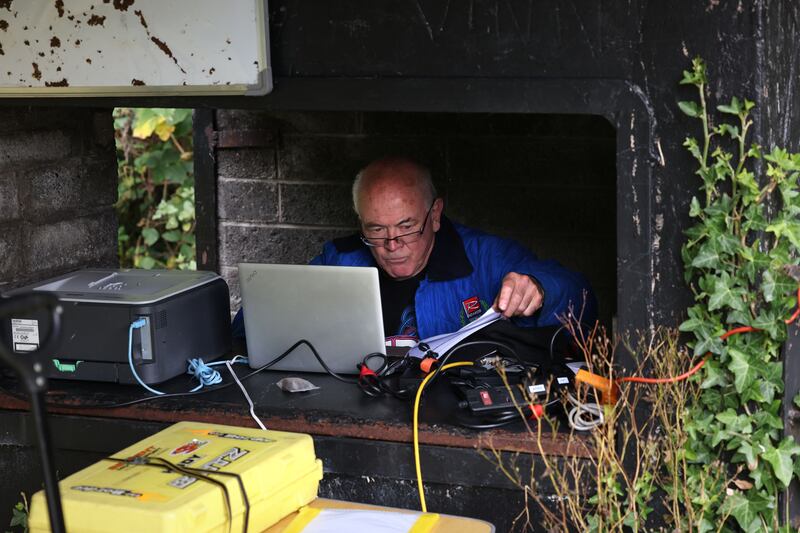 Race controller Denis Fox checking lap times