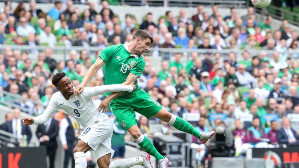 Robbie Brady gets above Raheem Sterling during the drab stalemate at the Aviva Stadium. Photograph: Gary Carr/Inpho