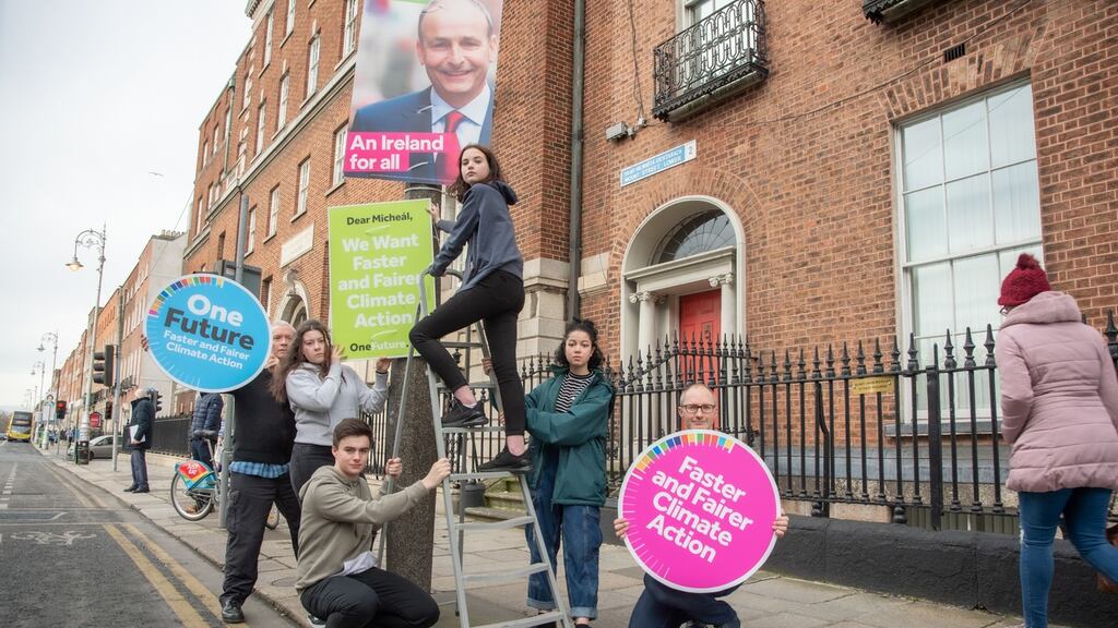 School climate strikers deliver key election demands: Conor Slattery (17), Réiltín Courtney (14), Mya Farrell on ladder (13) and Chaya Smyth (14). They are with Kevin Farrell and Oisin Coghlan.