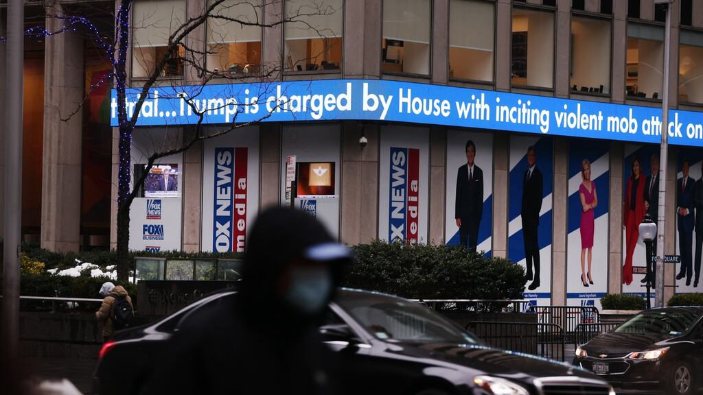 News headlines on the impeachment trial of Donald Trump outside Fox headquarters in New York. Photograph: Spencer Platt/Getty