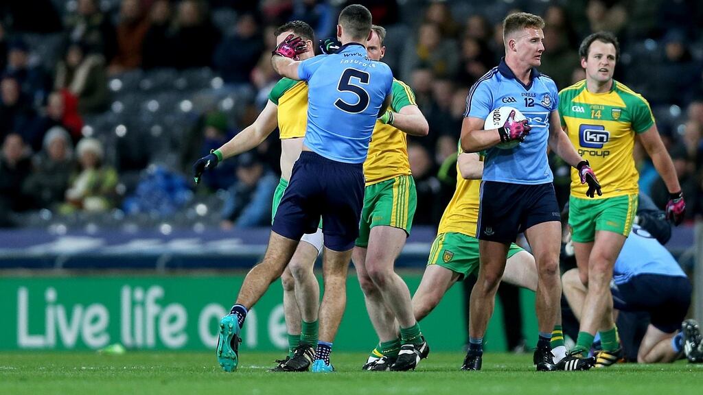 Dublin’s James McCarthy clashes with Donegal’s Martin McElhinney at Croke Park. Photograph: Donall Farmer/Inpho