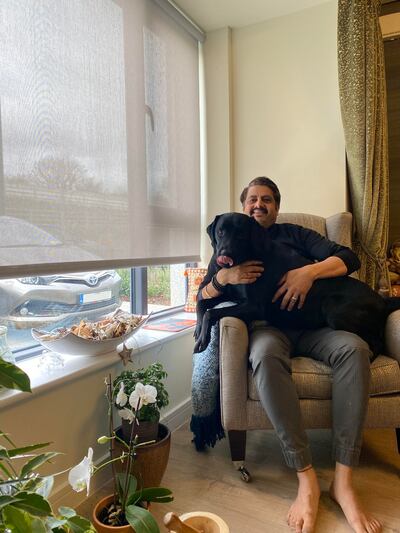 Sunil Ghai with dog Junior on his 1933 Furniture Company chair