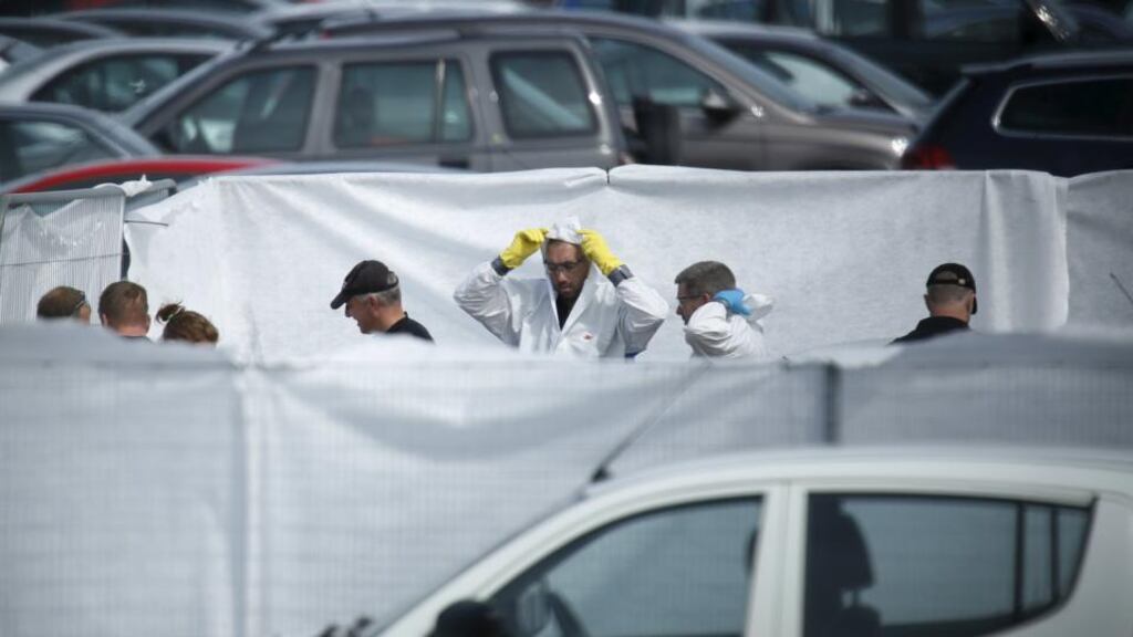 Crash investigors inspect the site of an airplane crash at the British Car Auctions lot next to Blackbushe Airport. Photograph: Luke MacGregor/The Irish Times
