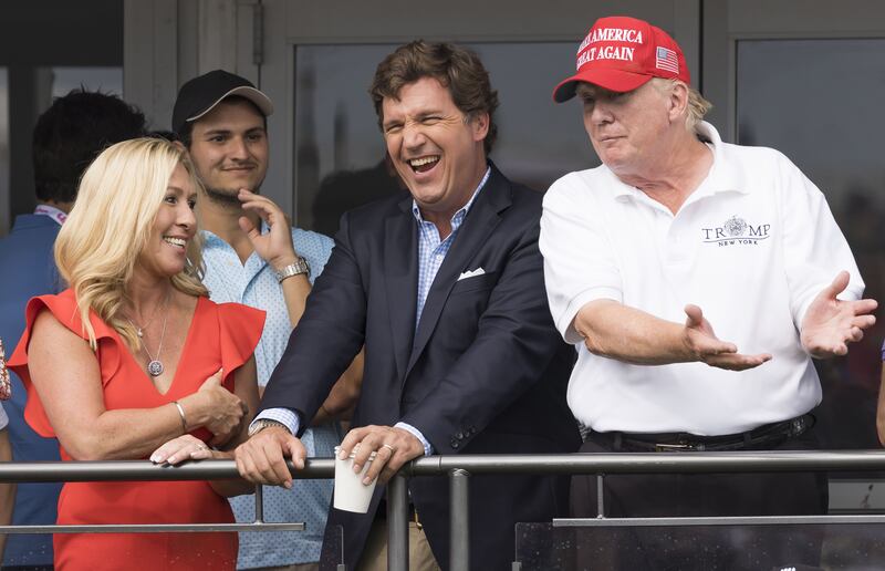 Republican congresswoman Majorie Taylor Greene, Fox News television personality Tucker Carlson, and former US president Donald Trump. Taylor Greene opposes Kevin McCarthy's bid to become House speaker. Her view is supported by Carlson. Photograph: Justin Lane