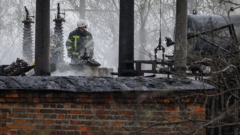 A firefighter surveys the damage at traction substation building near rail lines, which officials said were the target of a Russian missile attack, near Lviv, Ukraine. Photograph: Leon Neal/Getty Images