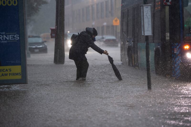 A commuter makes their way to a bus through floodwaters on Friday morning in the Bronx. Photograph: Gregg Vigliotti/New York Times