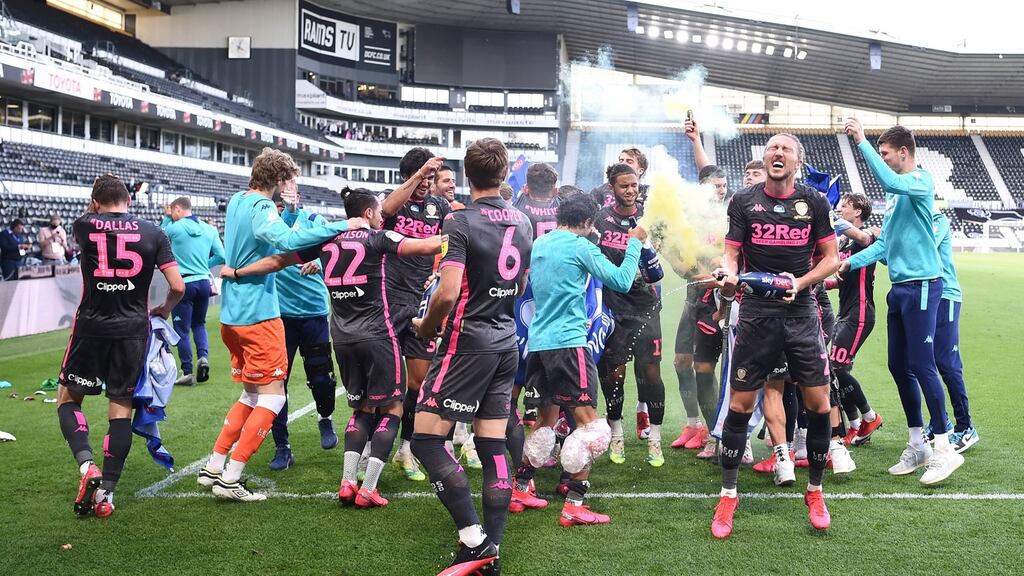 Newly crowned Championship winners Leeds United celebrate after their win against Derby County at Pride Park. Photograph: Getty Images