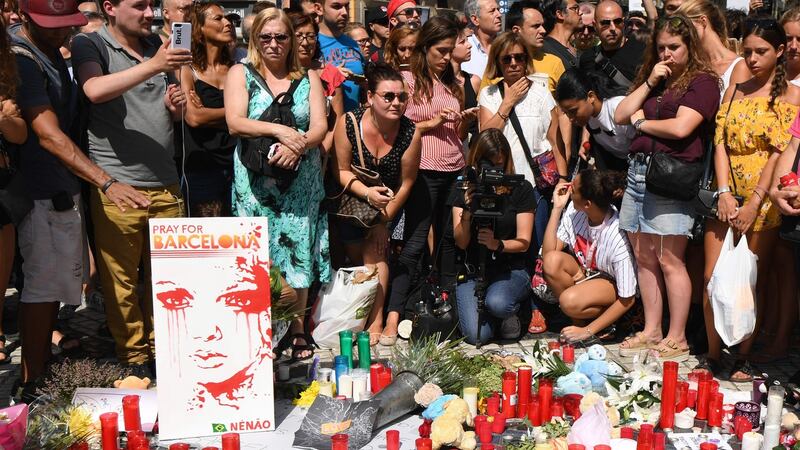 ‘Pray for Barcelona’: Crowds have gathered on Las Ramblas to pay tribute to the victims of the attack which killed 13 and injured more than 100. Photograph: Pascal Guyot/AFP/Getty Images
