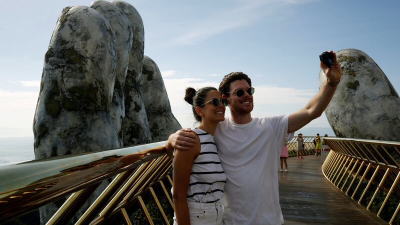 Tourists take a photograph on Cau Vang, or Golden Bridge, near Danang in Vietnam. Photograph: Kham/Reuters