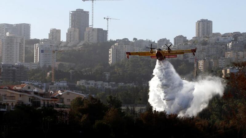 A firefighting plane drops fire-retardant over a wildfire in the northern city of Haifa, Israel, November 25th, 2016. Photograph: Baz Ratner/Reuters