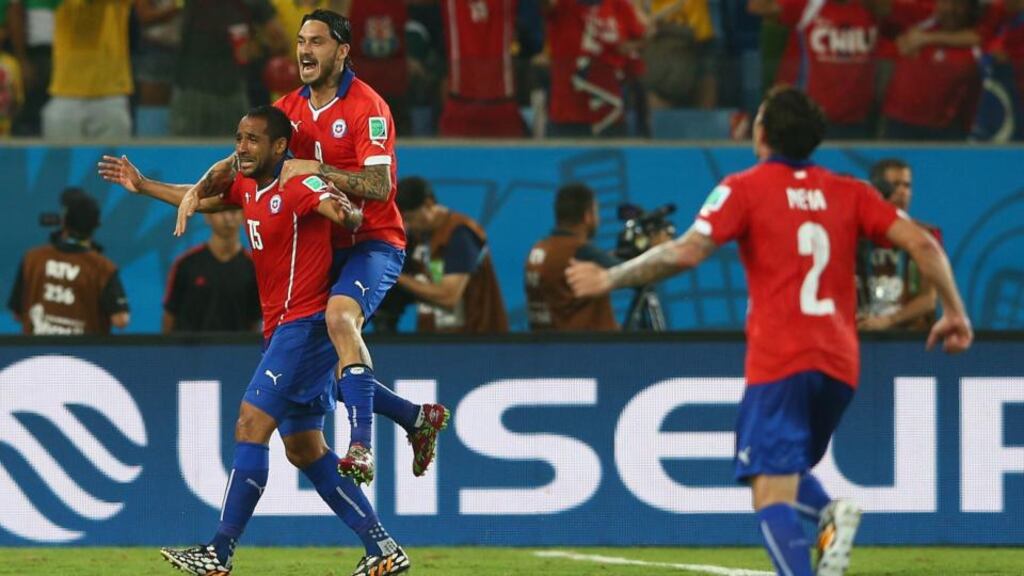 Jean Beausejour celebrates scoring Chile’s third goal with Mauricio Pinilla during the World Cup Group B match against Australia at Arena Pantanal in Cuiaba, Brazil. Photograph: Cameron Spencer/Getty Images