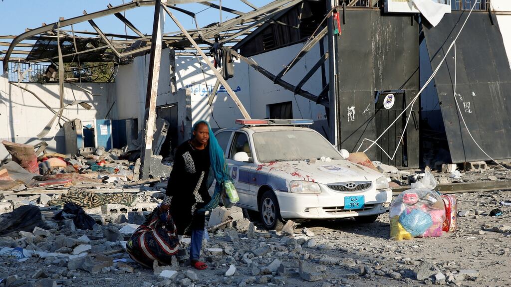 A woman picks up her belongings from among rubble at a detention centre that was hit by an airstrike in the Tajoura suburb of Tripoli on July 3rd, 2019. Photograph: REUTERS/Ismail Zitouny