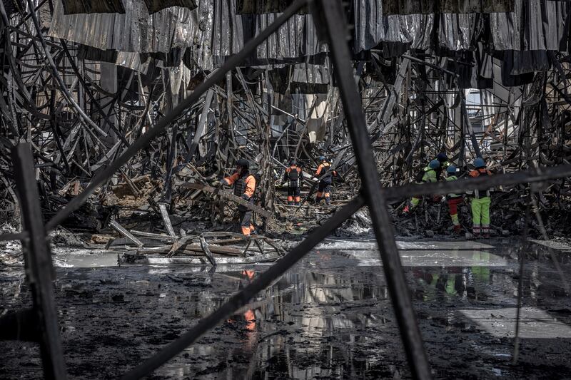 Emergency workers at the scene of a hardware superstore in Kharkiv that was hit by a Russian strike. Photograph: Finbarr O'Reilly/New York Times