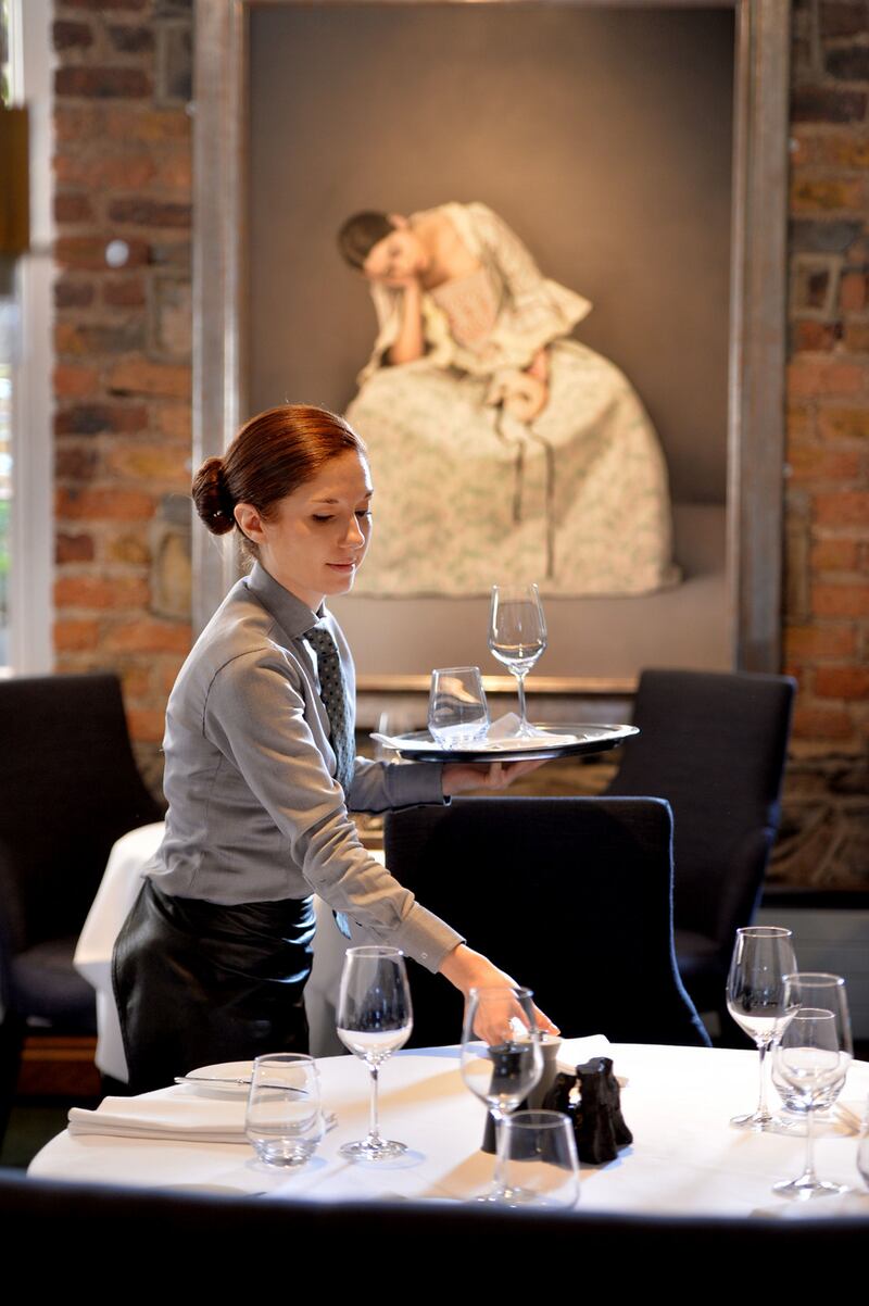Marina Jacques of the front-of-house staff preparing for clients