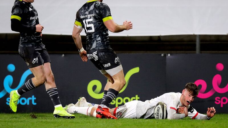 Ethan McIlroy slides in to score Ulster’s second try against Munster. Photograph: Ryan Byrne/Inpho