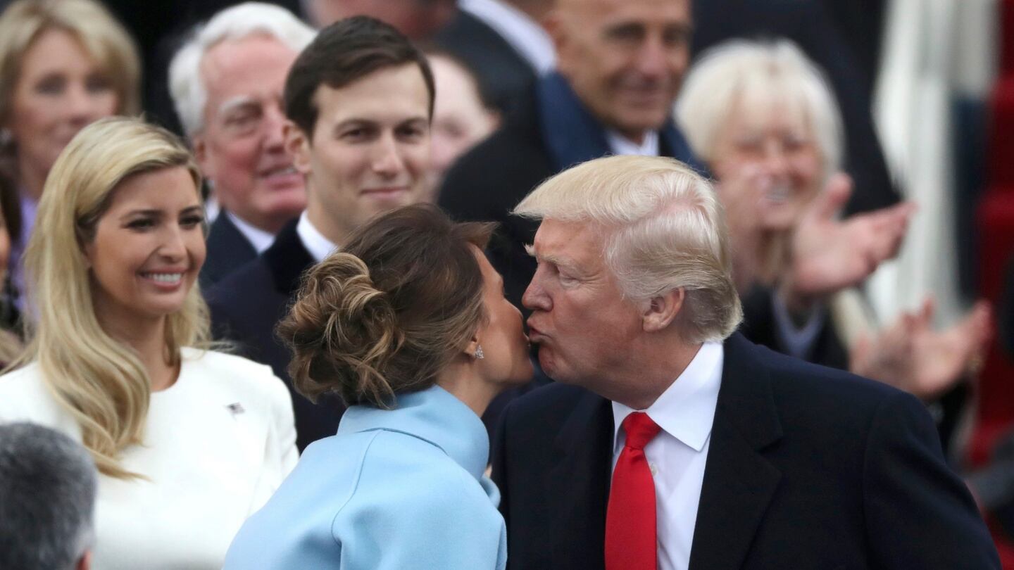 US president-elect Donald Trump kisses his wife Melania as he attends his inauguration on the Capitol in Washington. Photograph: Carlos Barria/Reuters