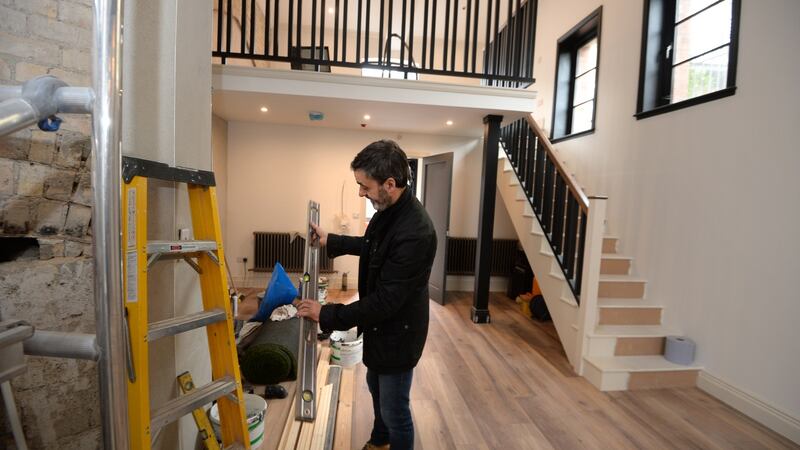 Emmet Long, a builder who developed his own business buying and flipping properties, pictured working on a ‘fixer upper’ apartment in Blackpitts, Dublin. Photograph: Dara Mac Dónaill