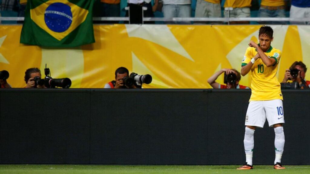 Brazil’s Neymar celebrates after scoring a free kick against Italy . Photograph: Kai Pfaffenbach/Reuters