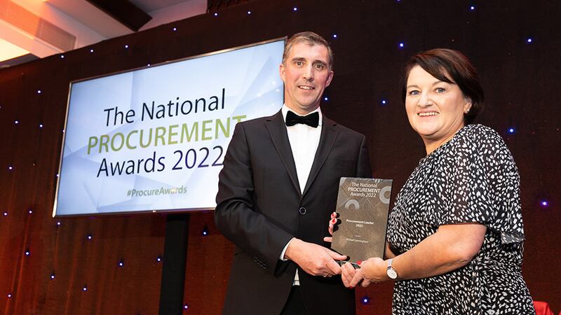 Francis Kehoe, Judging Co-ordinator, presents the Procurement Leader 2022 award to Catherine Cunningham on behalf of Michael Cunningham.