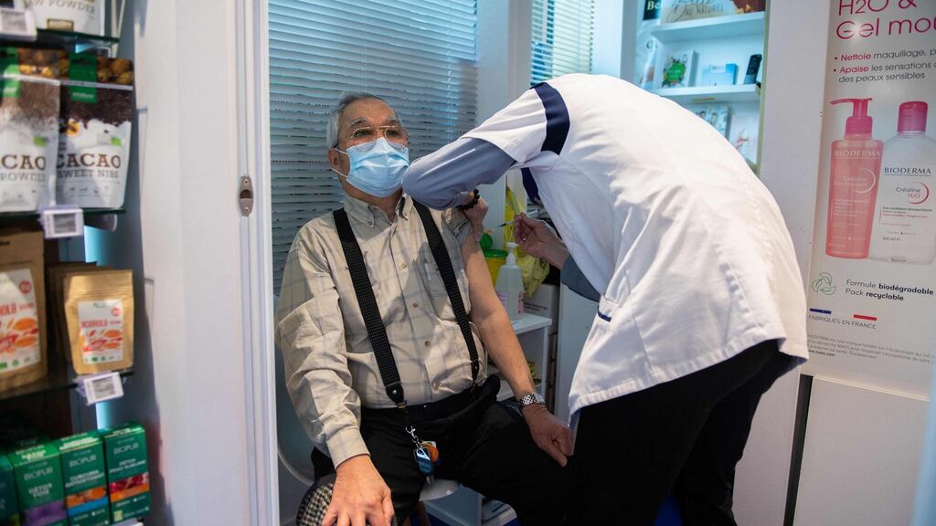 A pharmacist gives a shot of an AstraZeneca Covid-19 vaccine at a pharmacy in Paris. Photograph: Martin Bureau/AFP via Getty Images
