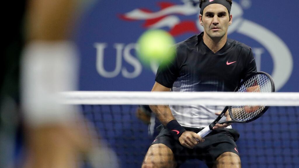 Roger Federer returns to Feliciano Lopez during their third round clash at the U.S. Open in New York. Photo: Julio Cortez/AP