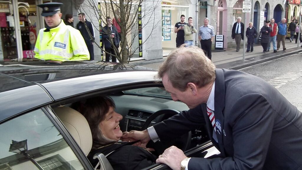 Enda Kenny talks to a voter during an election visit to Ballina. Photograph: Anthony Hickey
