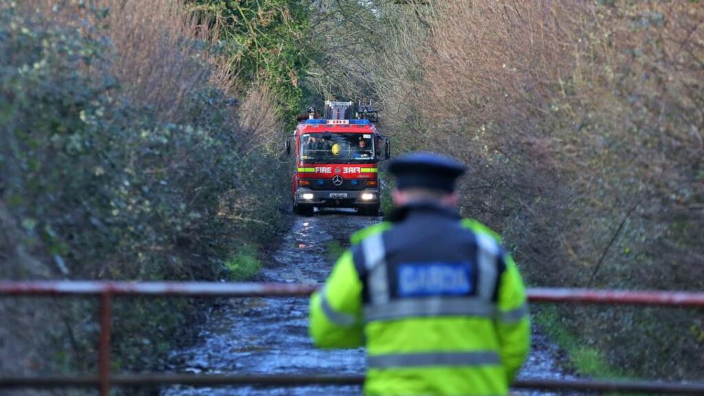 Firefighters pictured at the scene in Kilbride, near Clara, Co Offaly where the body of a man was discovered this morning in an open drain. Photograph: Colin Keegan/Collins.