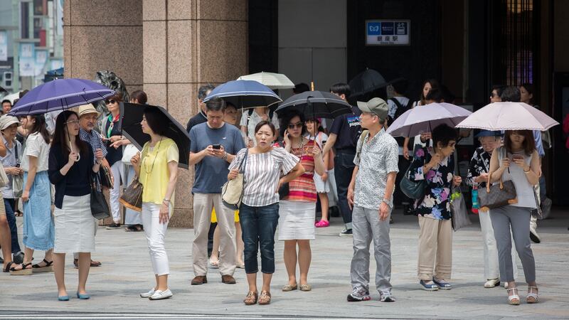 People use parasols to try to escape the heat on Sunday in Ginza, Tokyo. Photograph: Yuichi Yamazaki/Getty Images