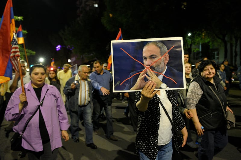 A protestor holds a crossed-out portrait of Armenia's Prime Minister Nikol Pashinyan during an anti-government rally in downtown Yerevan. Photograph: Karen Minasyan/AFP