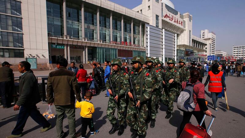 Armed policemen patrol near the exit of the railway station in Urumqi, Xinjiang in 2014. Photograph: Reuters/Petar Kujundzic)