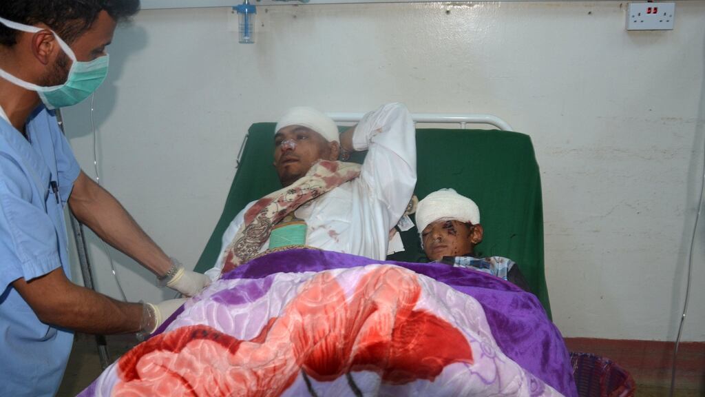 And injured man and boy in Dhamar province, Yemen, are treated in hospital following a rocket attack on a village. At least 25 people were killed in the strike which villagers said was probably carried out by Saudi-led coalition jets. Photograph: Reuters