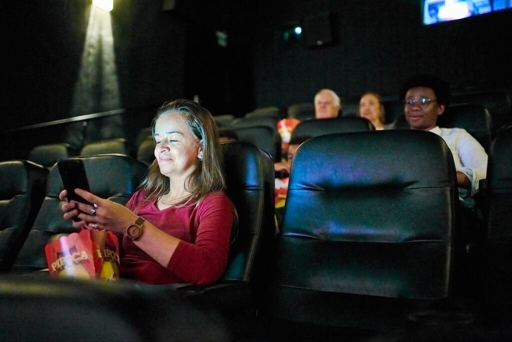“When she wasn’t providing a running commentary, or raucously laughing at mildly humorous scenes, she used the time to catch up with her notifications on Facebook.” Photograph: Getty Images