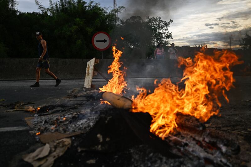 Supporters of President Jair Bolsonaro, mainly truck drivers, set a barrier on fire during a blockade on the Via Dutra BR-116 highway between Rio de Janeiro and Sao Paulo, in Volta Redonda, Rio de Janeiro state, on October 31st, as an apparent protest over Bolsonaro's defeat in the presidential run-off election. Photograph: Mauro Pimentel/AFP