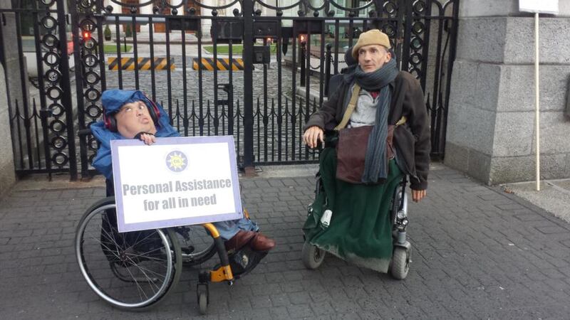 Protesters Aaron Abbey and Donal Toolan outside Government Buildings attempting to highlight cuts to services over seven years of austerity. Photograph: Rachel Flaherty