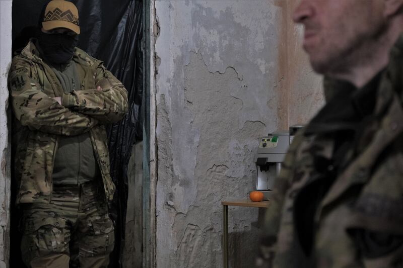 A Ukrainian serviceman (left) watches while a member of the Russian paramilitary group Wagner, a former criminal prisoner, sits in an interrogation room after being captured by Ukrainian soldiers near Bakhmut, Donetsk region, in March. He is not the subject of this interview.  Photograph: Sergey Shestak/AFP/Getty