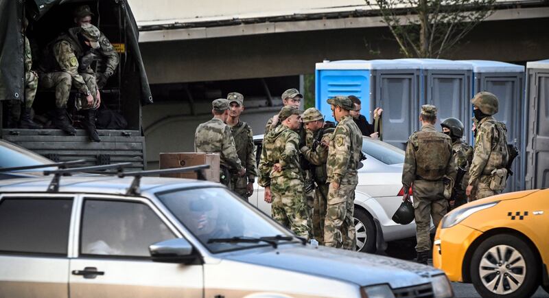 Russian soldiers stand at one of the highways entering Moscow on Saturday. Photograph: Alexander Nemenov/AFP via Getty Images