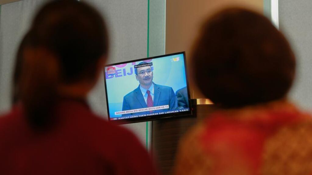 Journalists look at a TV screen broadcasting a news conference Malaysia’s acting Transport Minister Hishammuddin Hussein on the missing Malaysia Airlines flight MH370, inside the hotel where are relatives of the passengers of the missing Boeing 777-200ER are staying. Photograph: Samsul Said/Reuters