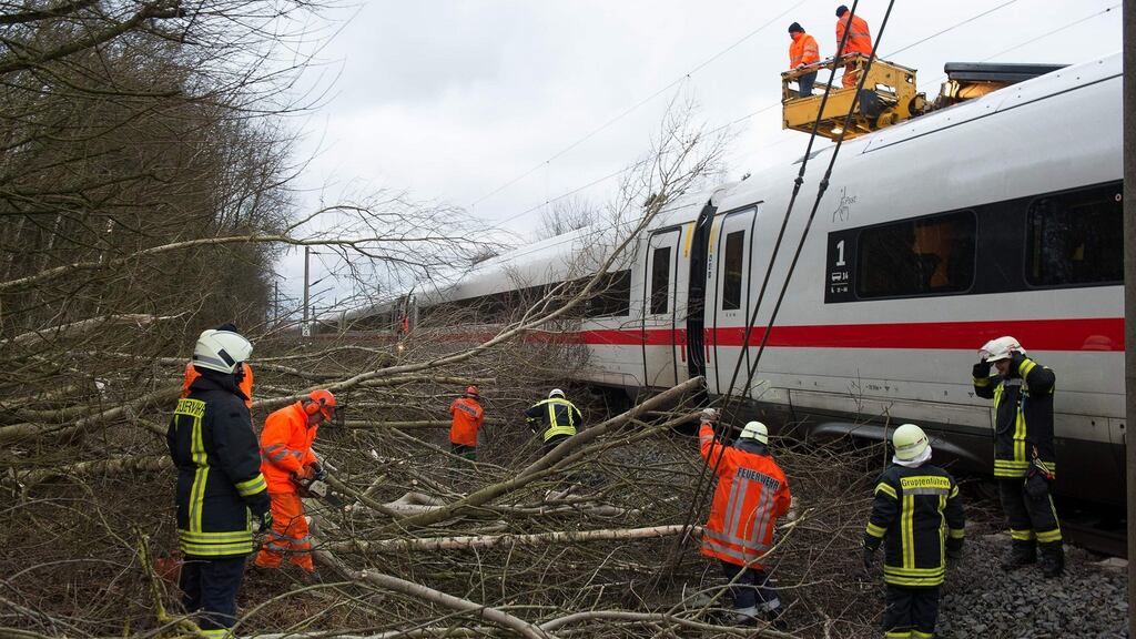 Firefighters removing trees which fell on a high-speed train near Lamspringe, northern Germany on Thursday. Photograph:  Outswen Pfortner/AFP/Getty Images