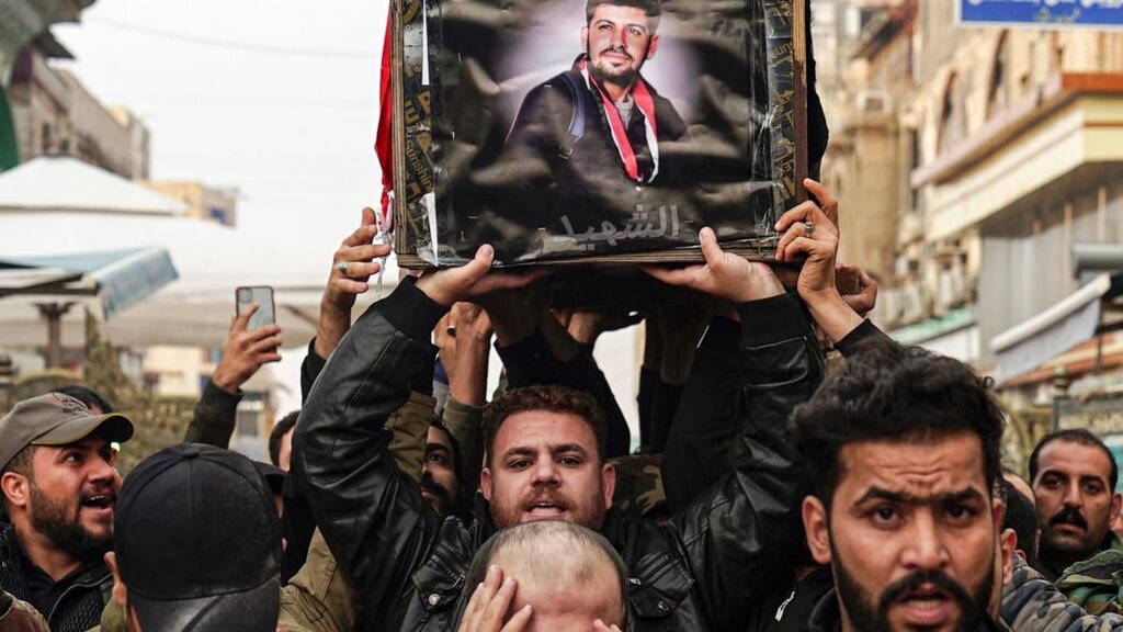 Iraqi mourners carry the coffin of a protester and citizen journalist killed at demonstrations in Baghdad. Photograph:  Haidar Hamdani/AFP