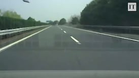 Dashcam shows top of truck container falling on moving car