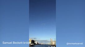 Onlookers film as the Red Arrows fly over Dublin