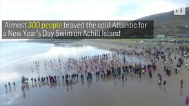 Hundreds of swimmers braved the icy waters of the Atlantic for New Year's dip