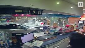 Outside in: car ploughs into shop, narrowly missing customer